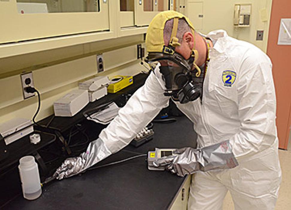 Christopher Neary of the NIST Environmental Management Group demonstrates the use of a handheld Raman spectrometer to determine the identity of an unknown sample.