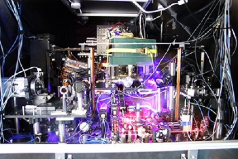  JILA’s experimental atomic clock based on strontium atoms held in a lattice of laser light is the world's most precise and stable atomic clock. The image is a composite of many photos taken with long exposure times and other techniques to make the lasers