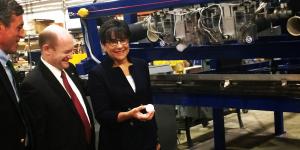 Secretary Penny Pritzker (third from left) holds a hail ball next to a large machine