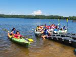 People in canoes on lake. 