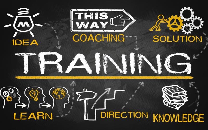 An image of blackboard with the word Training in the middle surrounded by another icon: idea, coaching, solution, learn, direction, knowledge