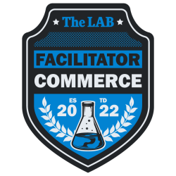 The LAB's facilitator badge in blue and black with a beaker representing the badge and wild olive leaves representing the department. 