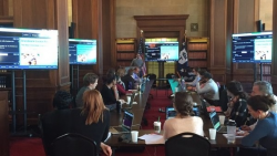 Commerce employees in the HCHB library with laptops, participating in a Data Academy training course