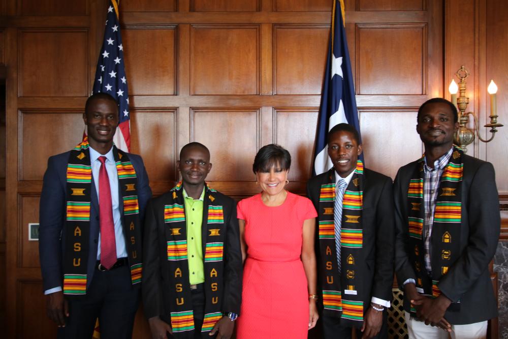 Secretary Penny Pritzker poses with four Mandela Washington Fellows