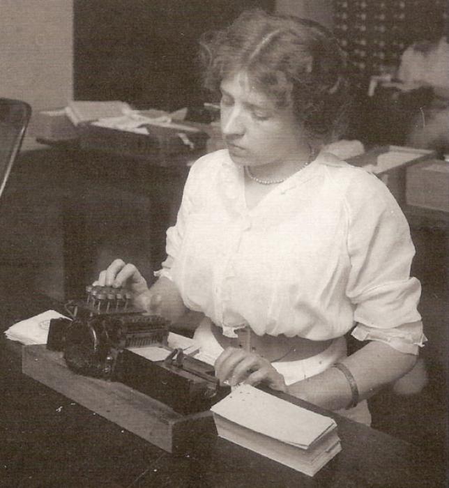 A female employee prepares punch cards for the 1920 census using a punch card machine