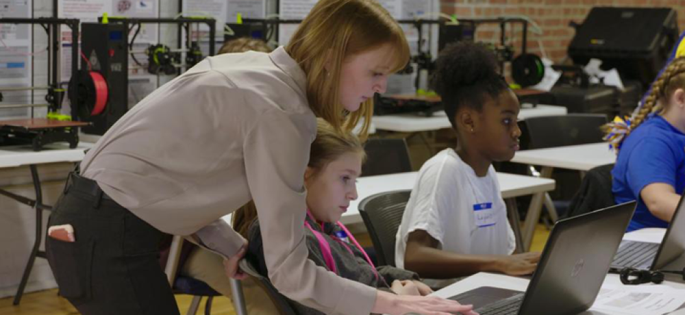 Ashley Totin, project engineer at America Makes, teaches children about 3D modeling and printing.