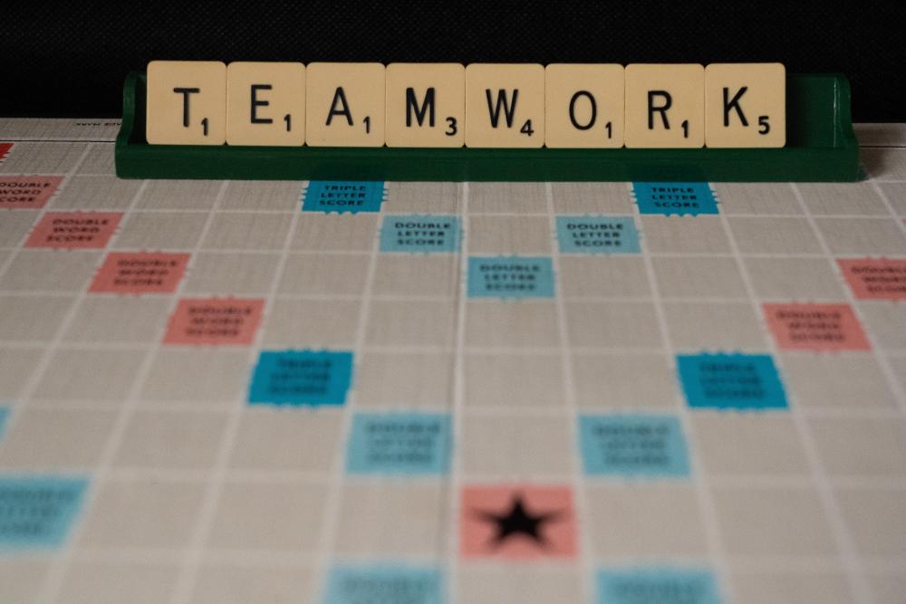 Scrabble board spelling out teamwork