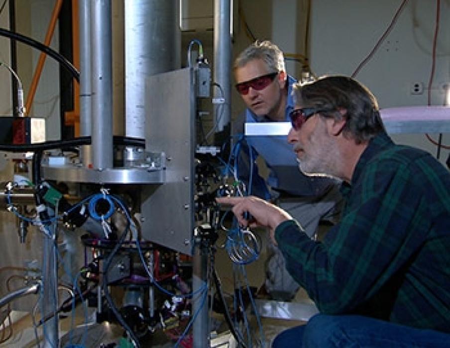 NIST physicists Steve Jefferts (foreground) and Tom Heavner with the NIST-F2 "cesium fountain" atomic clock, a new civilian time standard for the United States.