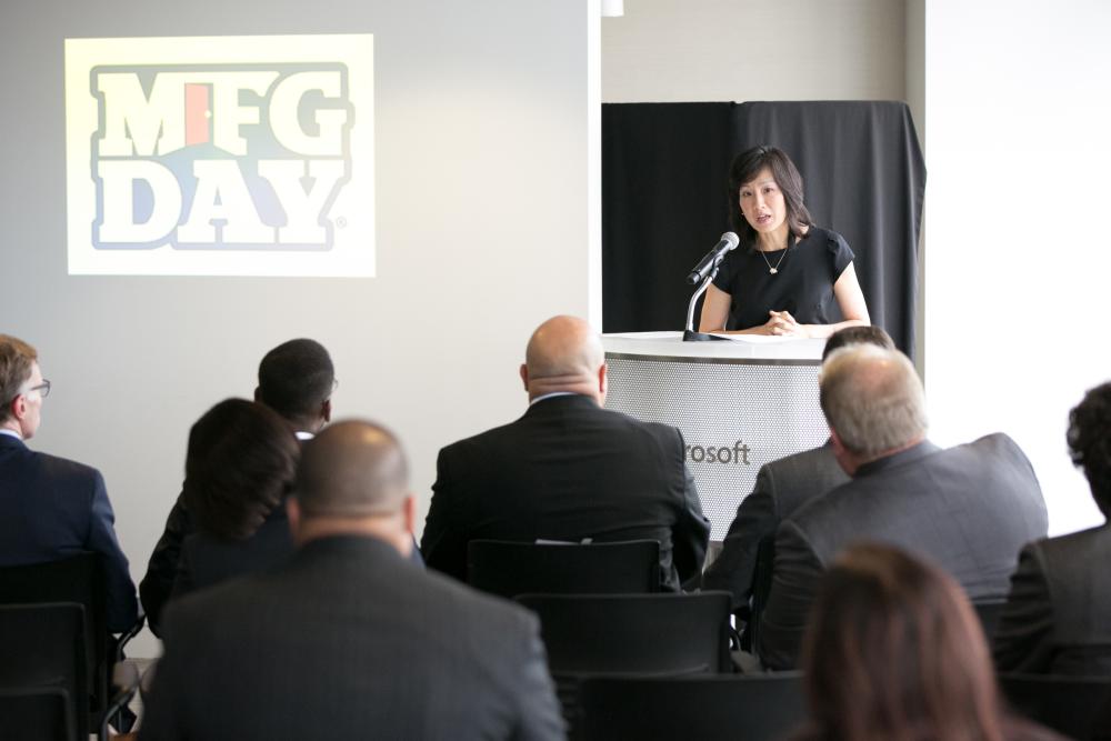 Michelle Lee speaking at a podium at the Microsoft Tech Lab