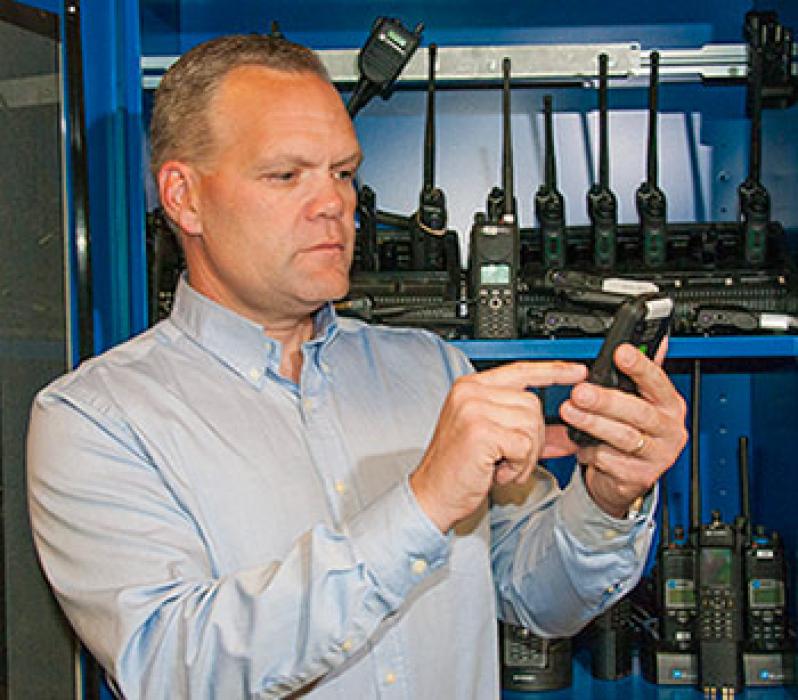 Dereck Orr with a variety of radios and cell phones used in NIST’s public safety communications research. A new NIST report outlines research needed on location-based services—applications such as GPS that can improve situational awareness for emergency r