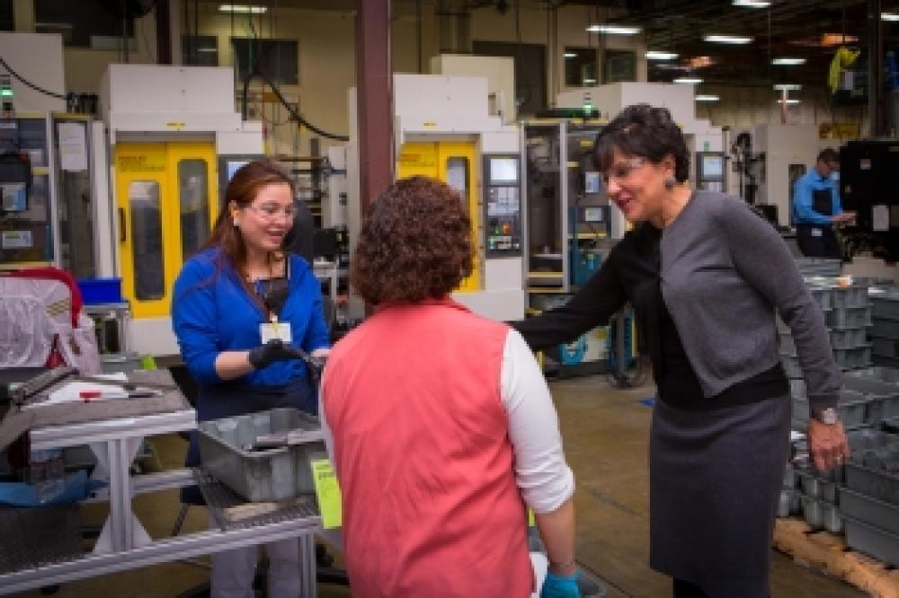 Secretary Pritzker talks with employees of the Leatherman Tool Group, Inc during a tour