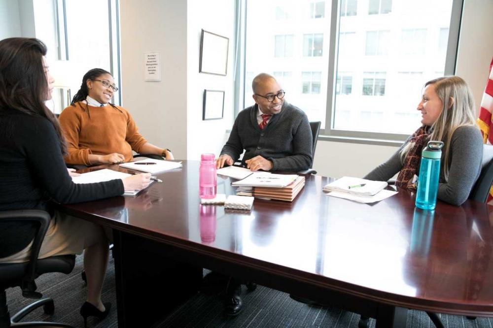 Bismarck Myrick (center) meets with staff at the U.S. Patent and Trademark Office’s Alexandria (Va.) campus