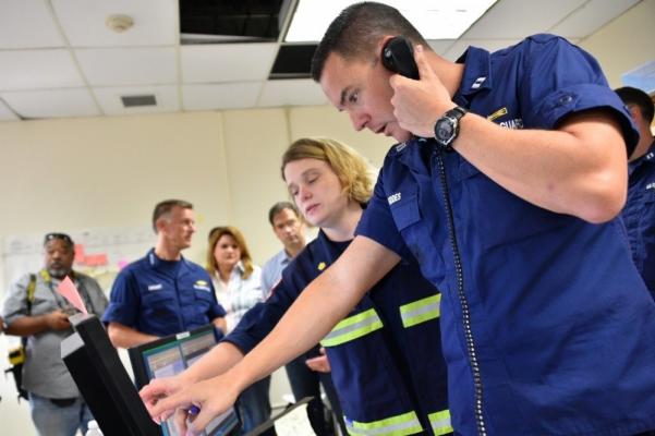 Andrew Fiddes (foreground) serving at Incident Command Post San Juan in the immediate aftermath of the devastating impacts of Hurricane Maria, is seen coordinating the initiation of the inflow of relief supplies in coordination with FEMA and Army/Navy elements.