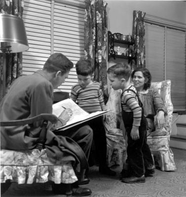 Photo of family filling out 1950 Census.