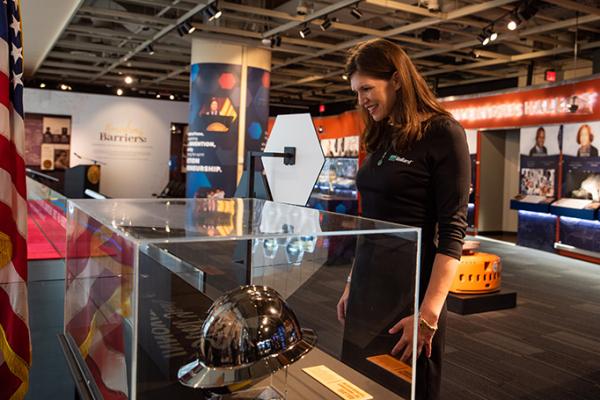 The great-granddaughter of inventor Edward Bullard visits the exhibit dedicated to his invention, the hard hat, at the National Inventors Hall of Fame Museum (Photo courtesy of the National Inventors Hall of Fame)