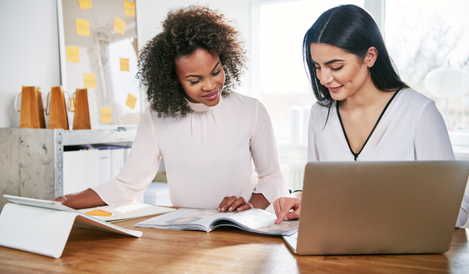 Two women working together