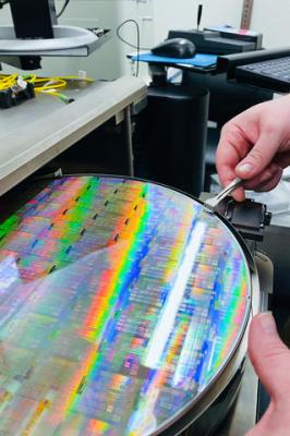 An integrated photonics silicon wafer fabricated at AIM Photonics, a Manufacturing USA institute in Albany, New York.  Credit: AIM Photonics