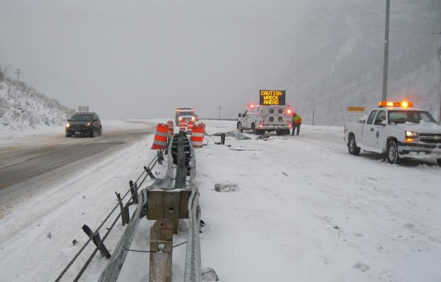 Photo of cars and hazard vehicles during snow storm