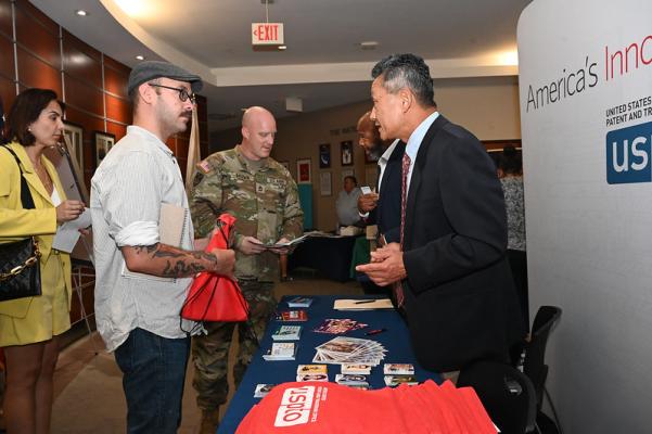 USPTO staff Alford Kindred and Harry Kim share entrepreneurship resources with military personnel and spouses at Hanscom Air Force Base.