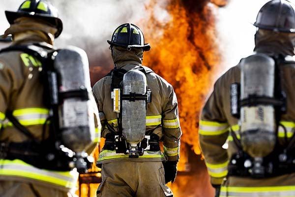 Photo of firefighters approaching a fire. Photo of firefighters approaching a fire.
