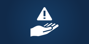 hand holding a caution sign