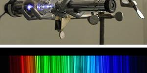 A thorium emissin lamp's violet glow, when viewed through a spectroscope, is split into a spectrum of thousands of bright lines.  New measurements of these lines could help astronomers search for earthlike planets around distant stars.