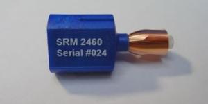 A NIST Standard Reference Material 2460 standard bullet mounted on a blue stub. Each one has six signature markings typically found in a fired bullet. 